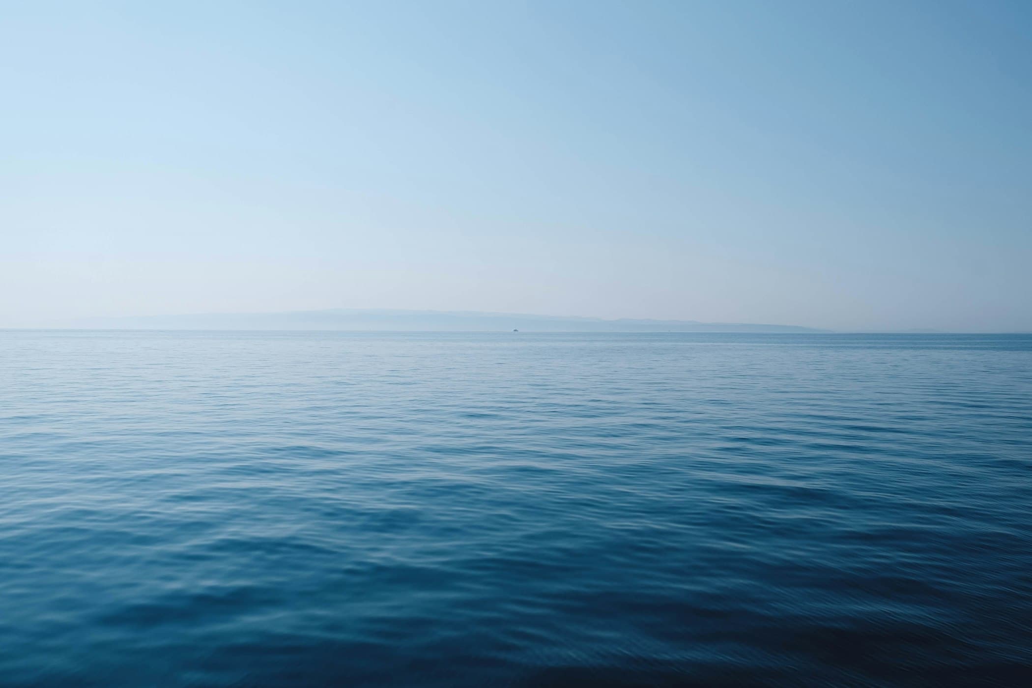 Long-exposure ocean horizon at first light — editorial photograph